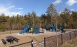 a playground with trees in the background